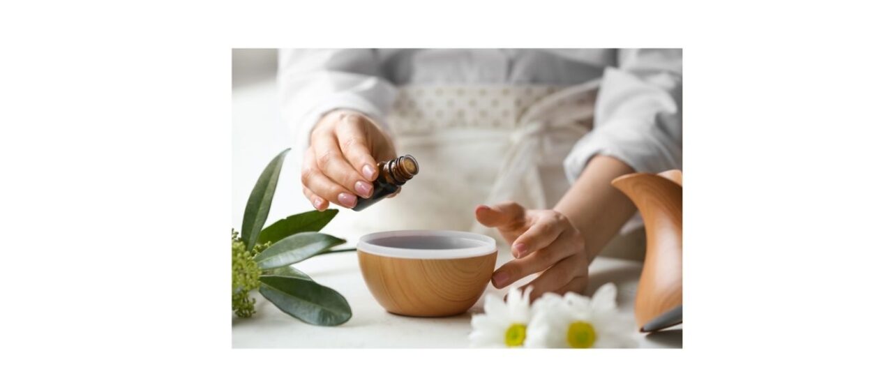 Lady putting essential oils into a diffuser